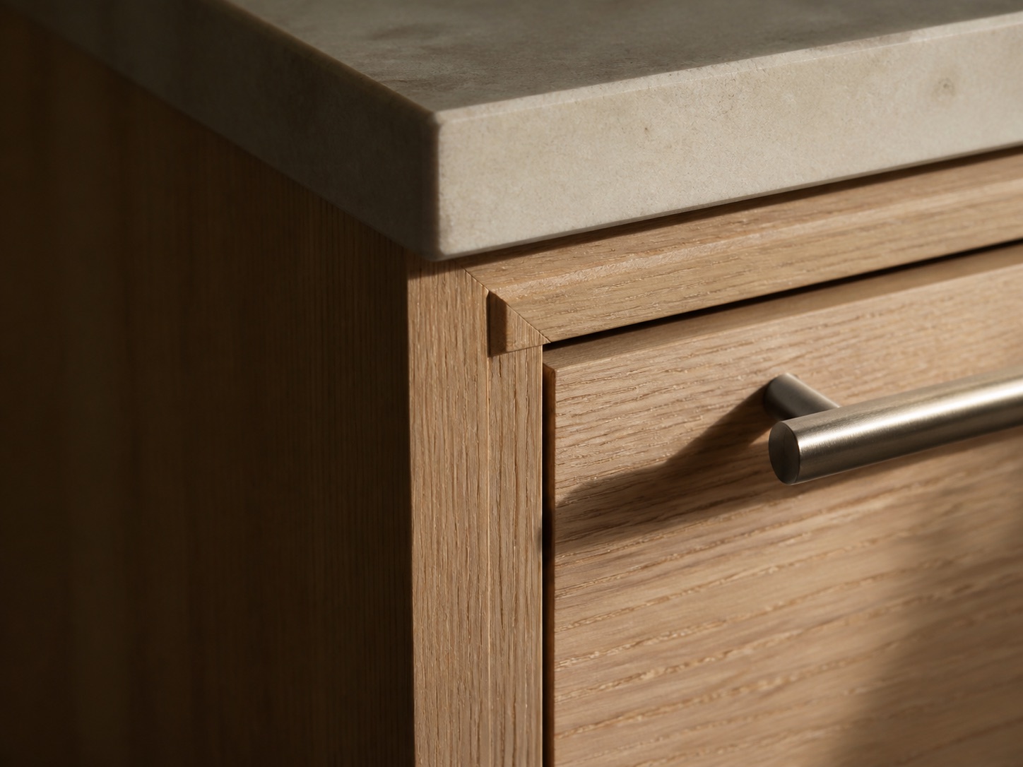 Refined bathroom finish detail with stone and wood cabinetry