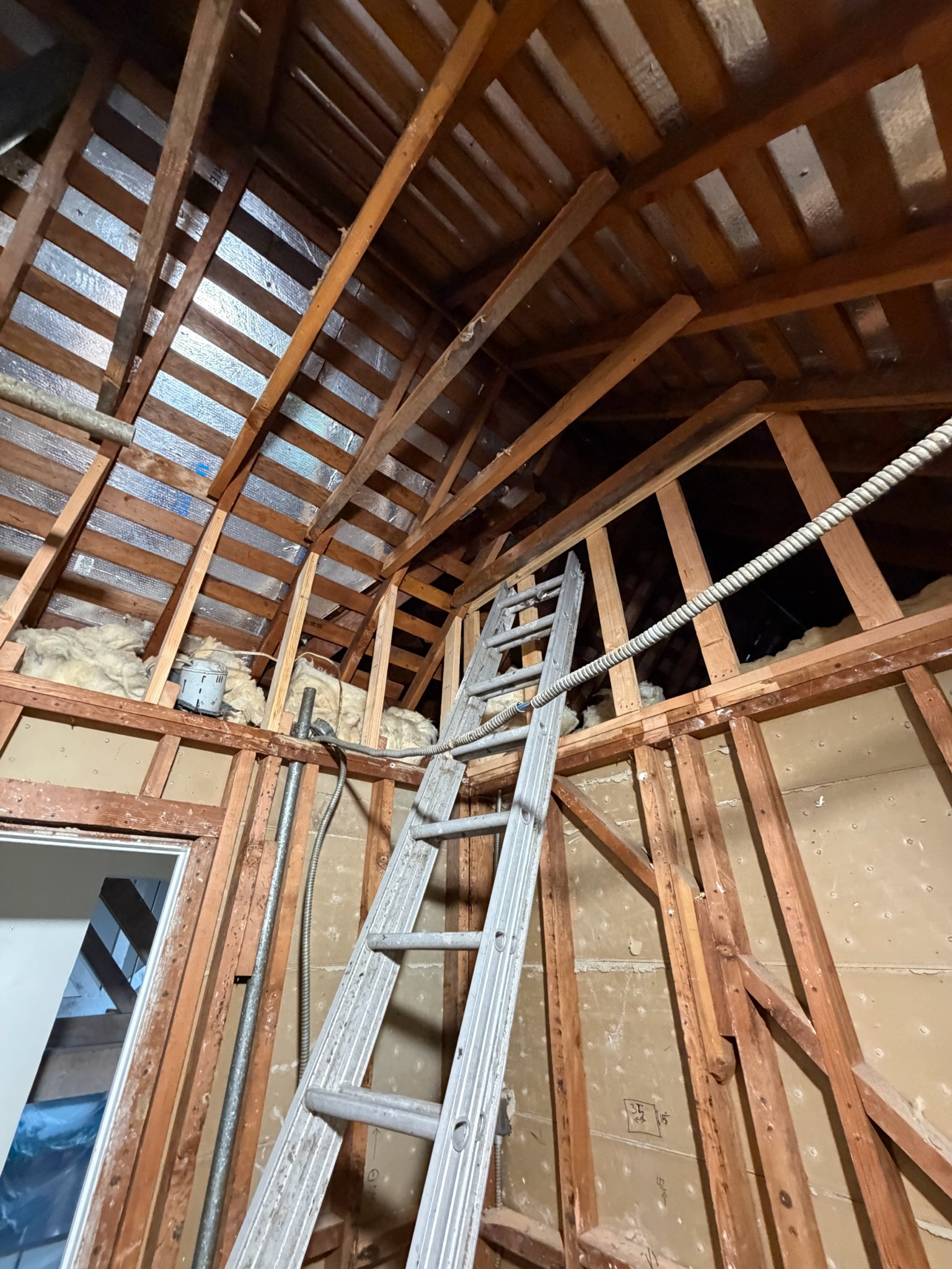 Exposed wood framing inside a Cedar and Stone residential renovation
